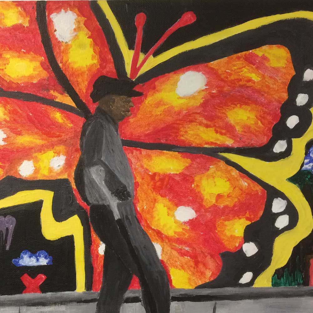 Painting of man in front of butterfly mural